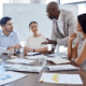 a group of people sitting around a conference table