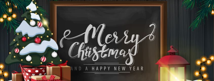 Merry Christmas and happy New Year, postcard with wooden wall, Christmas tree branches, garland, chalk board with lettering, old lantern and Christmas tree in a pot with gifts